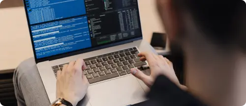 man using laptop to provide mobile app development services